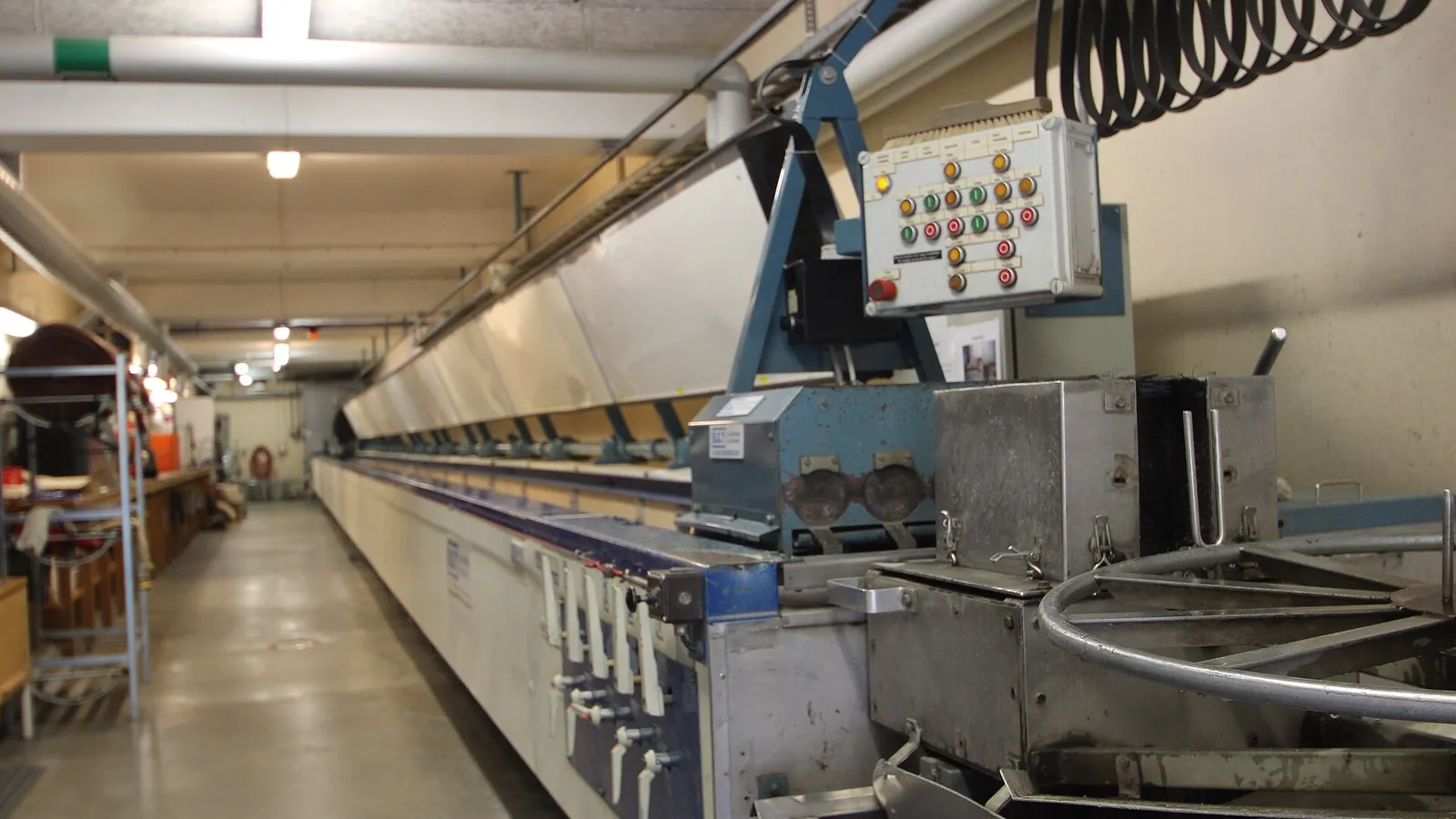 Hose production workshop line with coiled rubber hoses