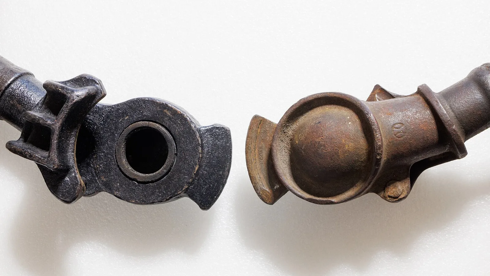 Camlock coupling halves separated on white background