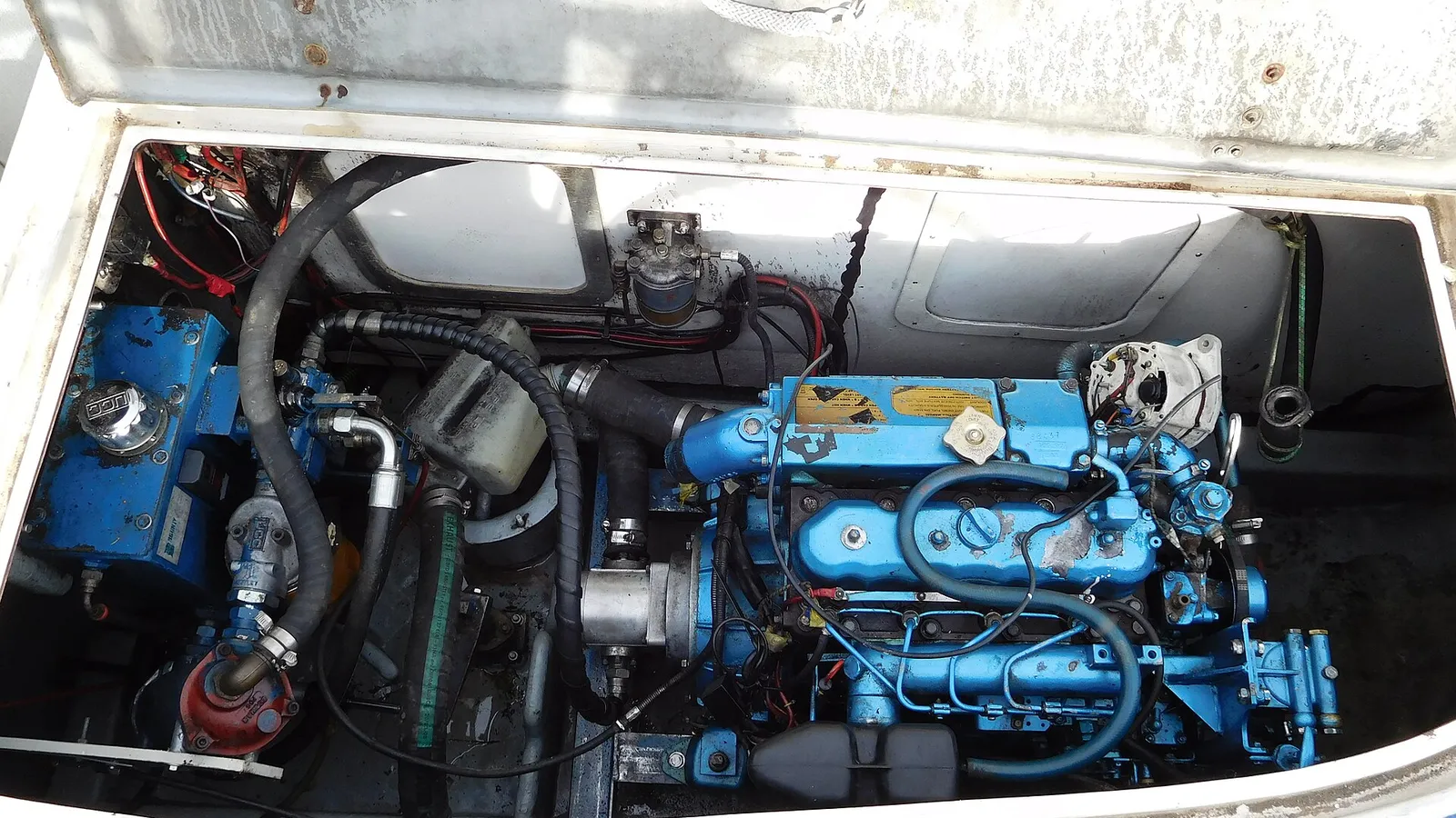 Engine room with black corrugated transfer hoses and piping