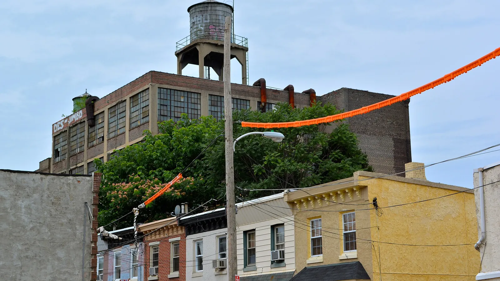 Factory exterior with hanging orange washdown hose