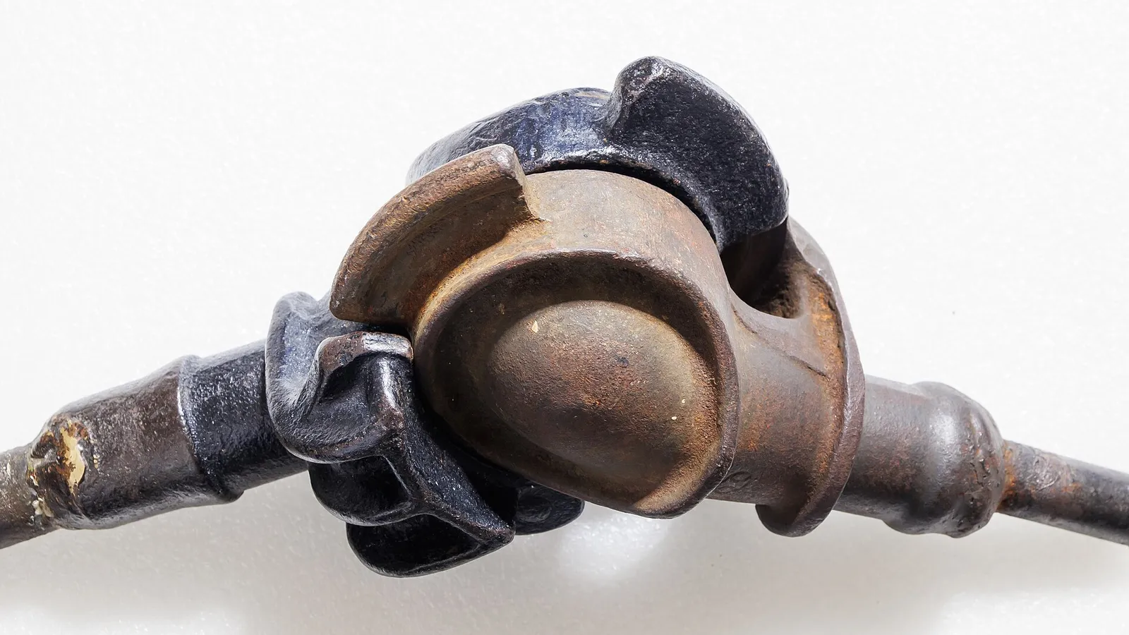 Side view of assembled camlock coupling with rust-toned half