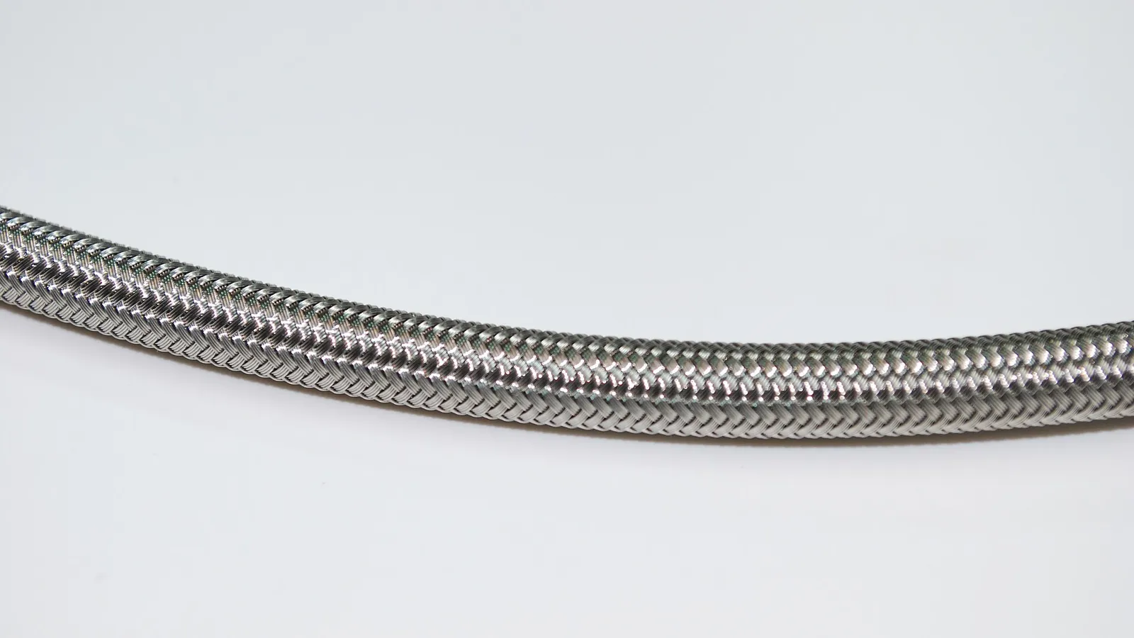 Stainless braided PTFE hose on white background